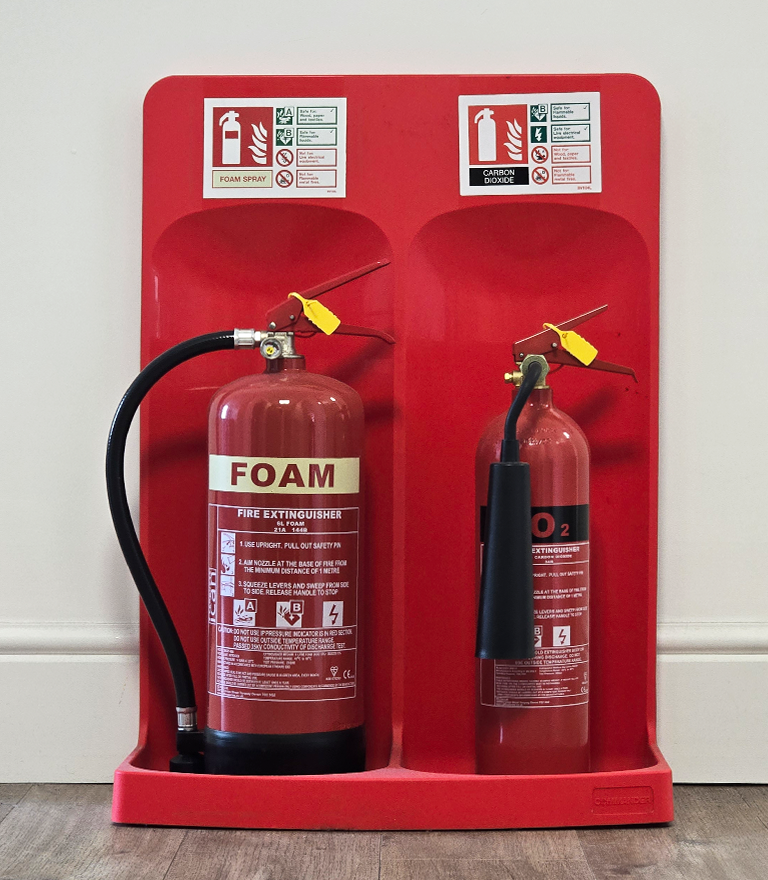 Westcountry fire protection employee holding a CO2 fire extinguisher.